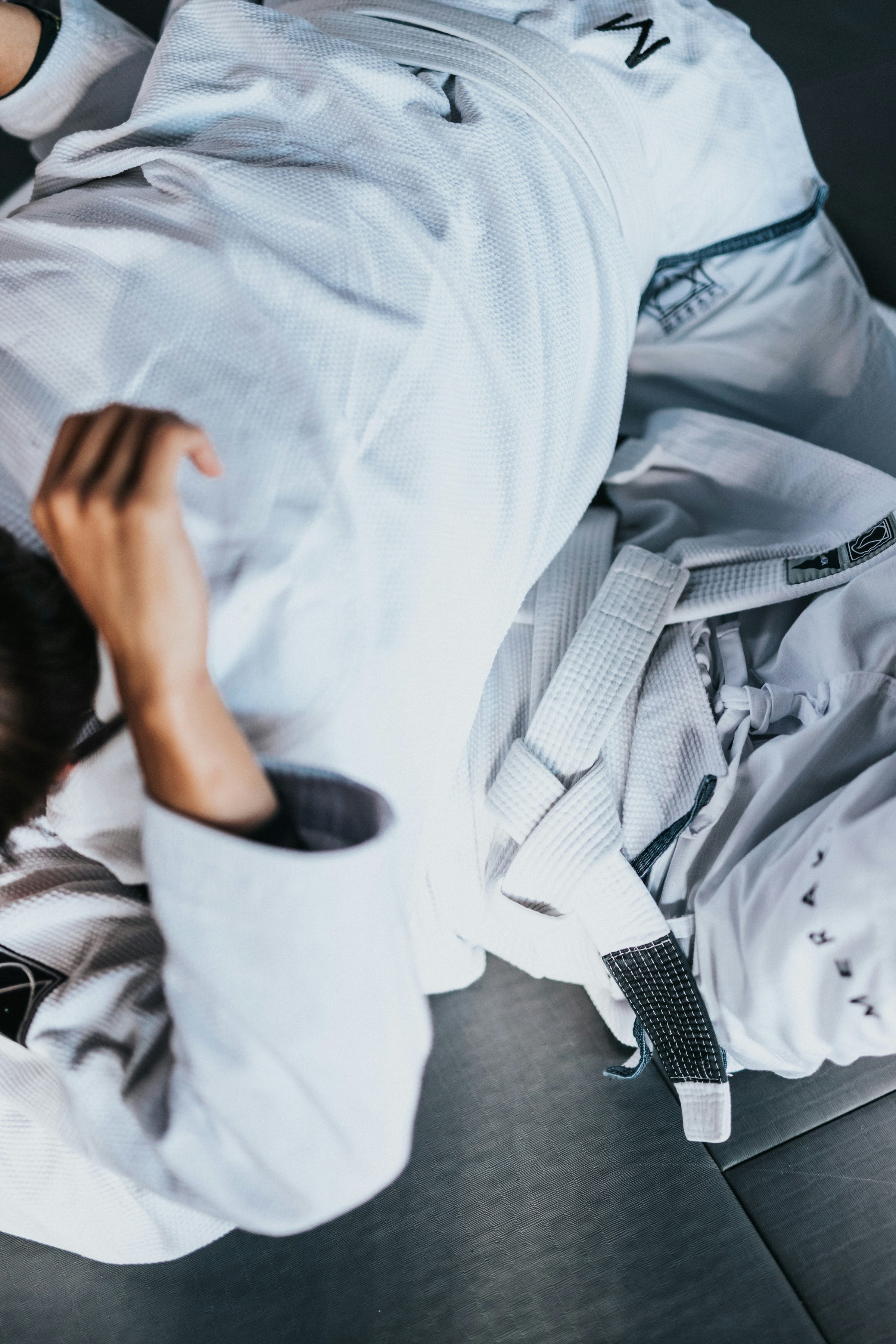 A sharp white belt tied over a gi during Brazilian jiu-jitsu training